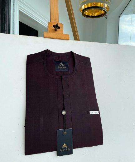 An eggplant purple, mid-section front flap, and piped pocket African traditional kaftan native