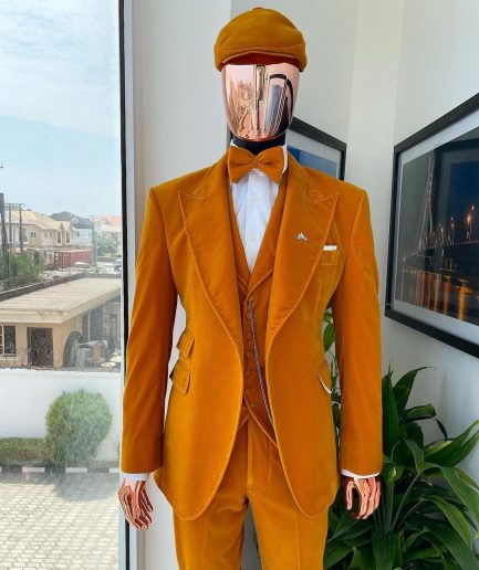 A reloaded monochrome “peaky blinders” hand knitted soaked Italian velvet ochre yellow peak lapel suit