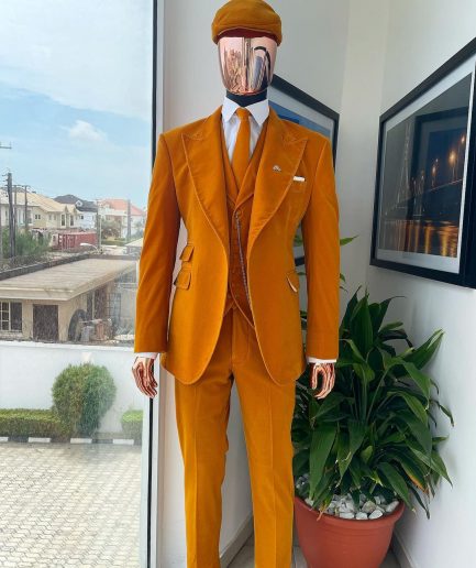 A reloaded monochrome “peaky blinders” hand knitted soaked Italian velvet ochre yellow peak lapel suit