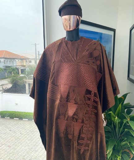 A chocolate brown royal embroidery design agbada, dashiki, hand-knitted matching hat, and Sokoto