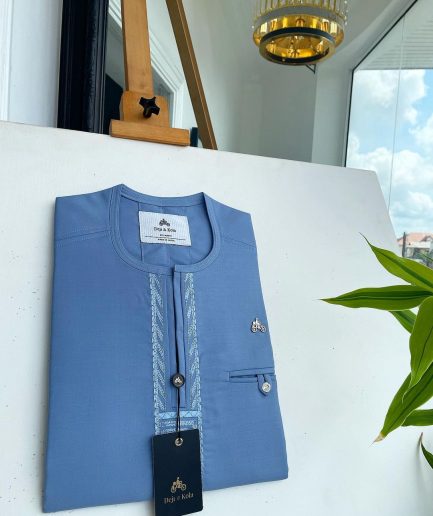 A Maya blue rail line flap with a combat pocket Swarovski button details African traditional senator Kaftan.