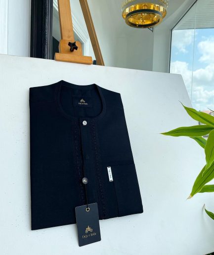 A Charcoal black front flap, interconnected embroidery, and a Swarovski button detail African traditional senator Kaftan native.