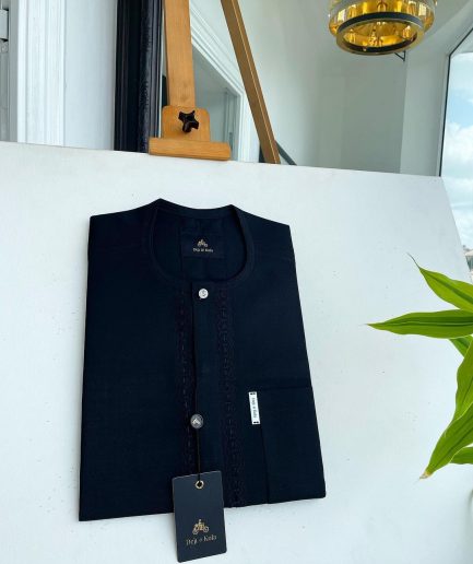 A Charcoal black front flap, interconnected embroidery, and a Swarovski button detail African traditional senator Kaftan native.