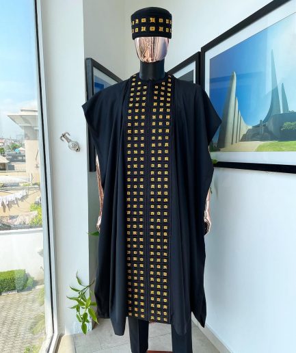 A Reloaded charcoal black, connected square embroidery design with matching gold and red Swarovski stone details agbada