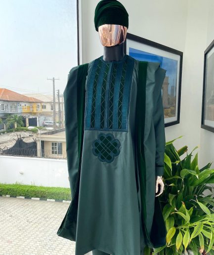 A reloaded British racing green Monochrome embroidery with soaked Italian velvet detailing agbada