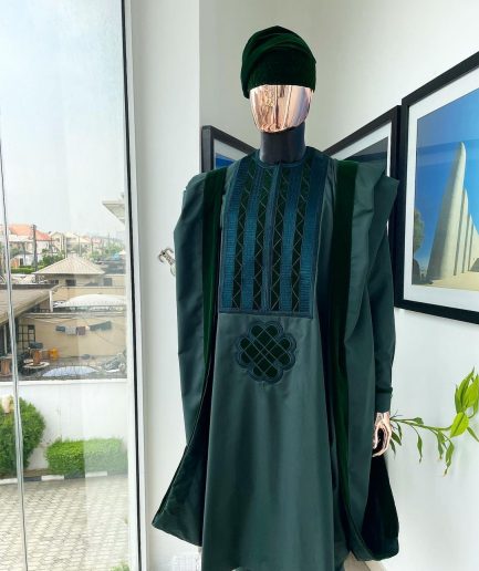 A reloaded British racing green Monochrome embroidery with soaked Italian velvet detailing agbada