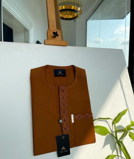 A caramel brown flap and pocket undulating with connected lane embroidery detailing African traditional senator Kaftan native