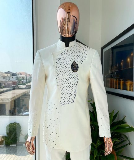 An ivory white, slide cut, navy blue dispersed safari suit with clustered Swarovski stone detailing