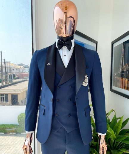 A Midnight Blue with black shawl lapel tuxedo suit