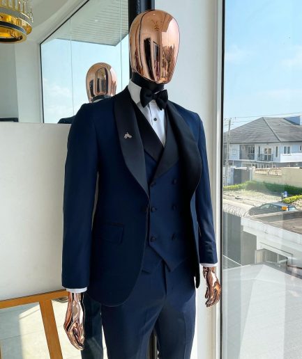 A Midnight Blue with black shawl lapel tuxedo suit