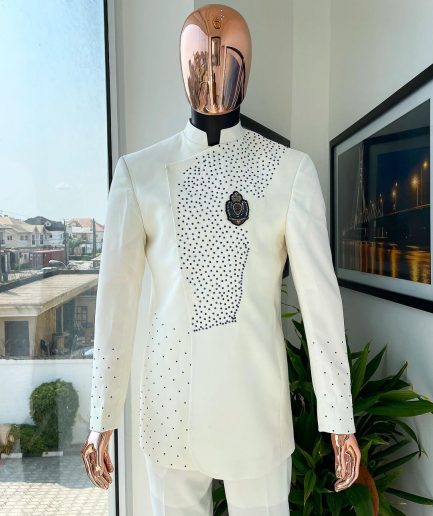 An ivory white, slide cut, navy blue dispersed safari suit with clustered Swarovski stone detailing
