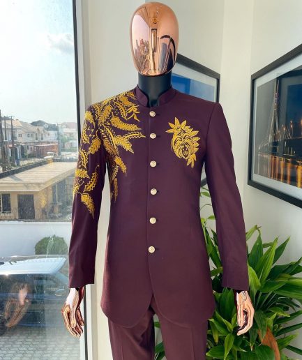 A burgundy safari suit with gold floral pattern embroidery detailing