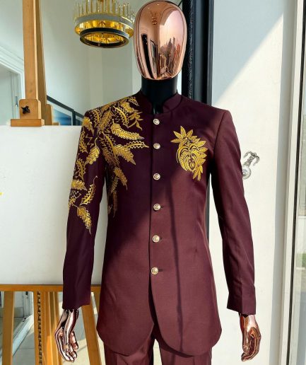 A burgundy safari suit with gold floral pattern embroidery detailing