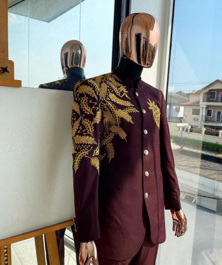 A burgundy safari suit with gold floral pattern embroidery detailing