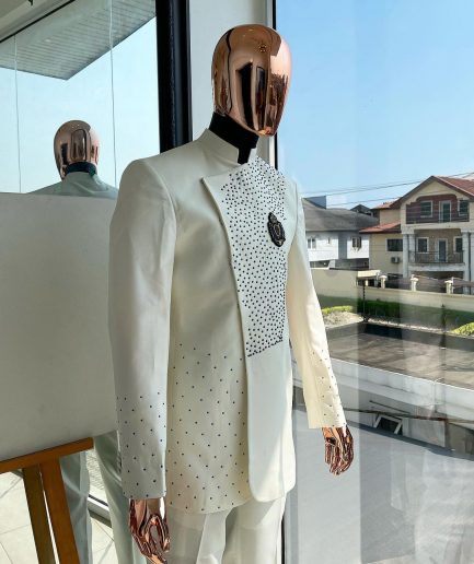 An ivory white, slide cut, navy blue dispersed safari suit with clustered Swarovski stone detailing