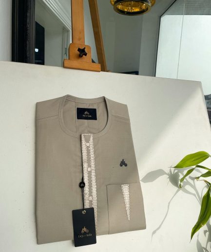 A tortilla brown, connected triangle front flap, and pocket embroidery detailing African traditional senator Kaftan native