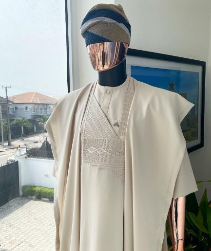 A coconut ivory, jakan design agbada, 3/4 sleeve buba laced with Swarovski stone button details and sokoto