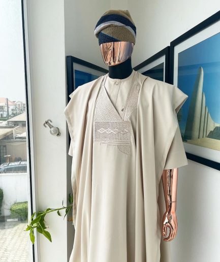 A coconut ivory, jakan design agbada, 3/4 sleeve buba laced with Swarovski stone button details and sokoto