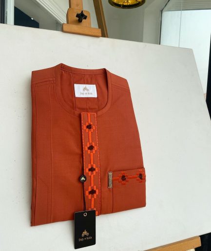 A fire orange, flap and front pocket undulating with connected lane embroidery detailing african traditional senator kaftan native.