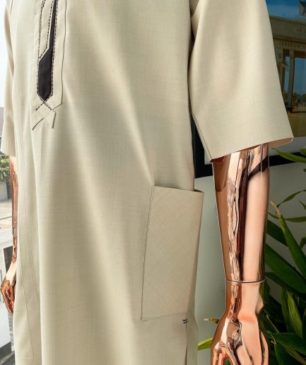 An Almond cream, lane, intersection flap, side patch pocket detailing african traditional senator kaftan native.