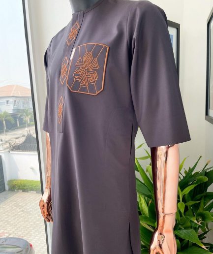 An umber brown, 3D precision anchor embroidery flap and pocket detailing African traditional senator Kaftan native