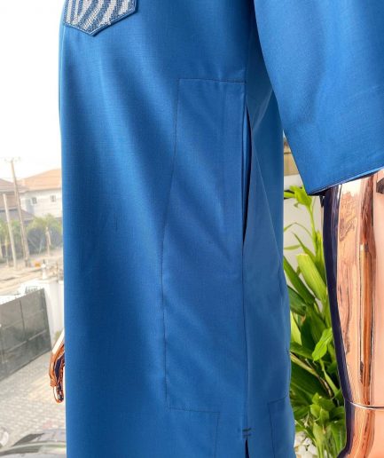 An azure blue, curly 3D embroidery flap and pocket detailing African traditional senator kaftan native