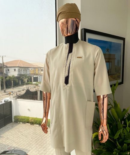 An Almond cream, lane, intersection flap, side patch pocket detailing african traditional senator kaftan native.