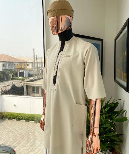 An Almond cream, lane, intersection flap, side patch pocket detailing african traditional senator kaftan native.
