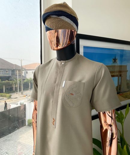 A Sand dollar beige, clear view Swarovski button with orange embroidery flap and pocket detailing African traditional senator kaftan native.