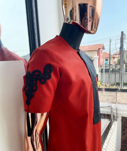 A Rosso corsa red, half cut black paisley detailing with mandarin knot button detailing african traditional senator kaftan native
