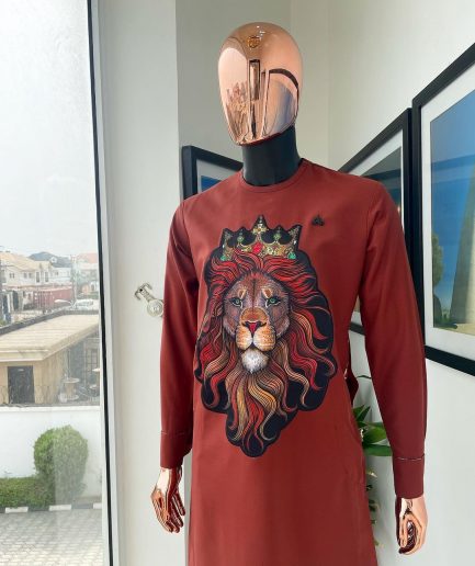 An Amber-orange piped neckline with a 3D lion king head patch stitched embroidery detailing African traditional senator kaftan native.