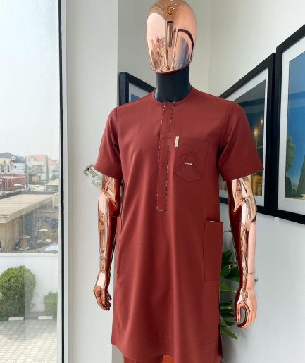 An Amber orange, paisley mountain top patch pocket detailing African traditional senator Kaftan native.
