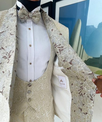 A gold print pattern tuxedo suit, contemplation cream with maroon, champagne gold floral metallic jacquard shawl lapel