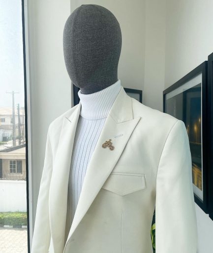 An Ivory white, x-large combat patch pocket, peak lapel suit