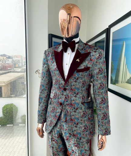 An “octopus” floral paisley tuxedo with right side strap mahogany red soaked Italian velvet peak lapel suit
