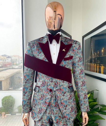 An “octopus” floral paisley tuxedo with right side strap mahogany red soaked Italian velvet peak lapel suit
