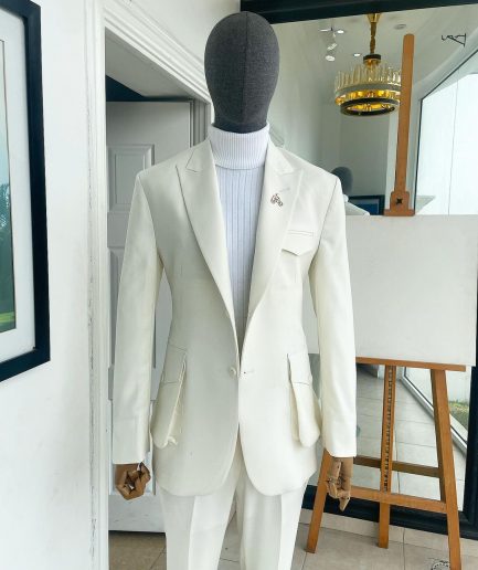 An Ivory white, x-large combat patch pocket, peak lapel suit