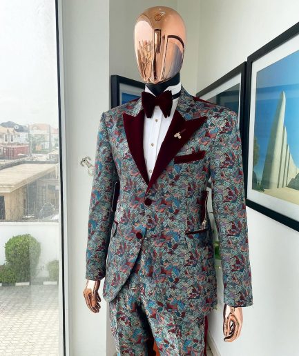 An “octopus” floral paisley tuxedo with intersected mahogany red soaked Italian velvet peak lapel suit