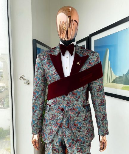 An “octopus” floral paisley tuxedo with left side strap mahogany red soaked Italian velvet peak lapel suit