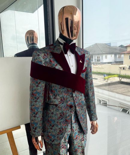 An “octopus” floral paisley tuxedo with right side strap mahogany red soaked Italian velvet peak lapel suit