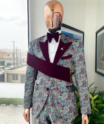 An “octopus” floral paisley tuxedo with right side strap mahogany red soaked Italian velvet peak lapel suit