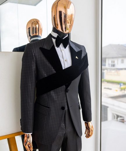 An “Octopus” black inverted square patterned jacquard tuxedo with left strap black velvet peak lapel suit
