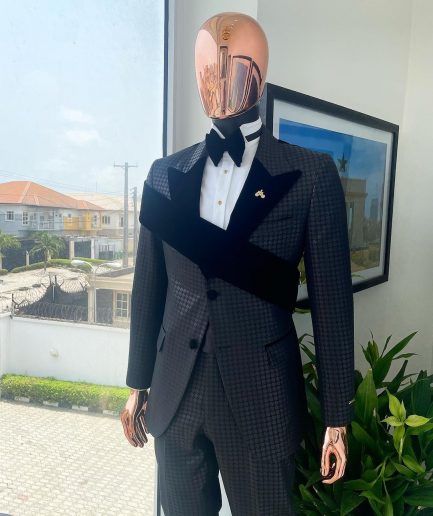 An “octopus” black inverted square patterned jacquard tuxedo with right strap black velvet peak lapel suit