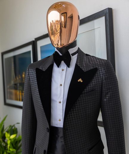 A Charcoal black inverted square patterned metallic jacquard tuxedo with charcoal black velvet peak lapel suit