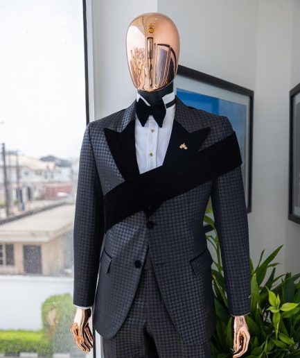 An “Octopus” black inverted square patterned jacquard tuxedo with left strap black velvet peak lapel suit