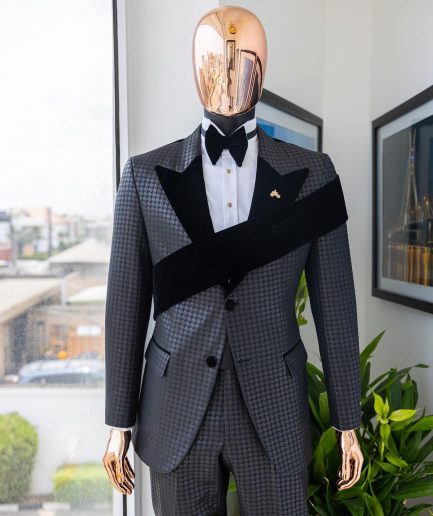 An “Octopus” black inverted square patterned jacquard tuxedo with left strap black velvet peak lapel suit