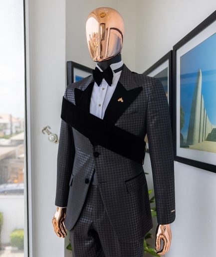 An “octopus” black inverted square patterned jacquard tuxedo with right strap black velvet peak lapel suit