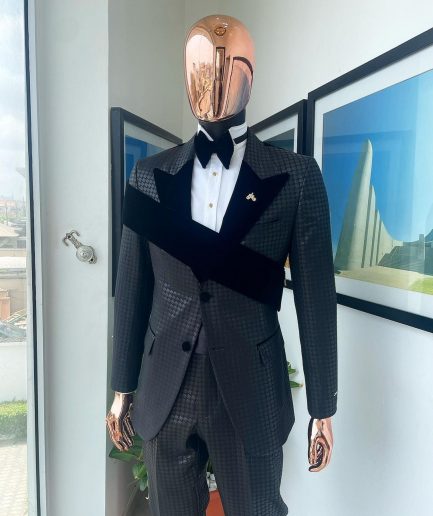 An “octopus” black inverted square patterned jacquard tuxedo with right strap black velvet peak lapel suit