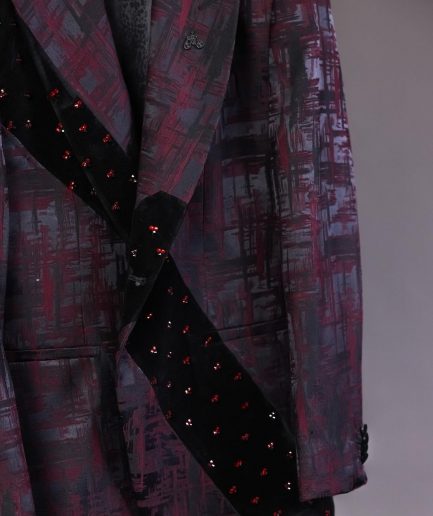 A diagonal cut layered black velvet Swarovski detailing burgundy and black patterned suit
