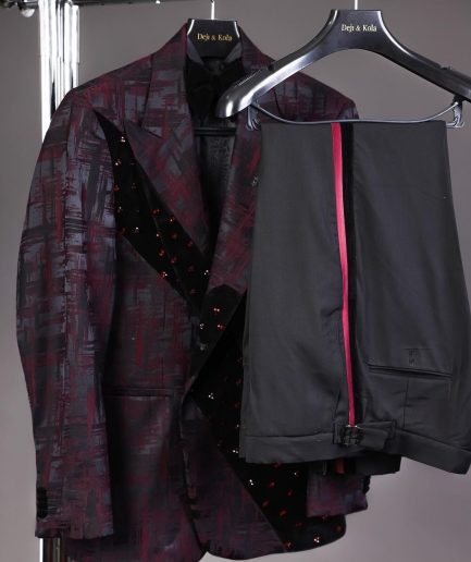 A diagonal cut layered black velvet Swarovski detailing burgundy and black patterned suit
